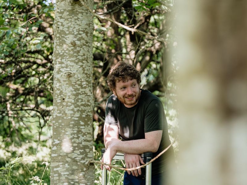 The Habitat People team member among the trees at Waterside Farm
