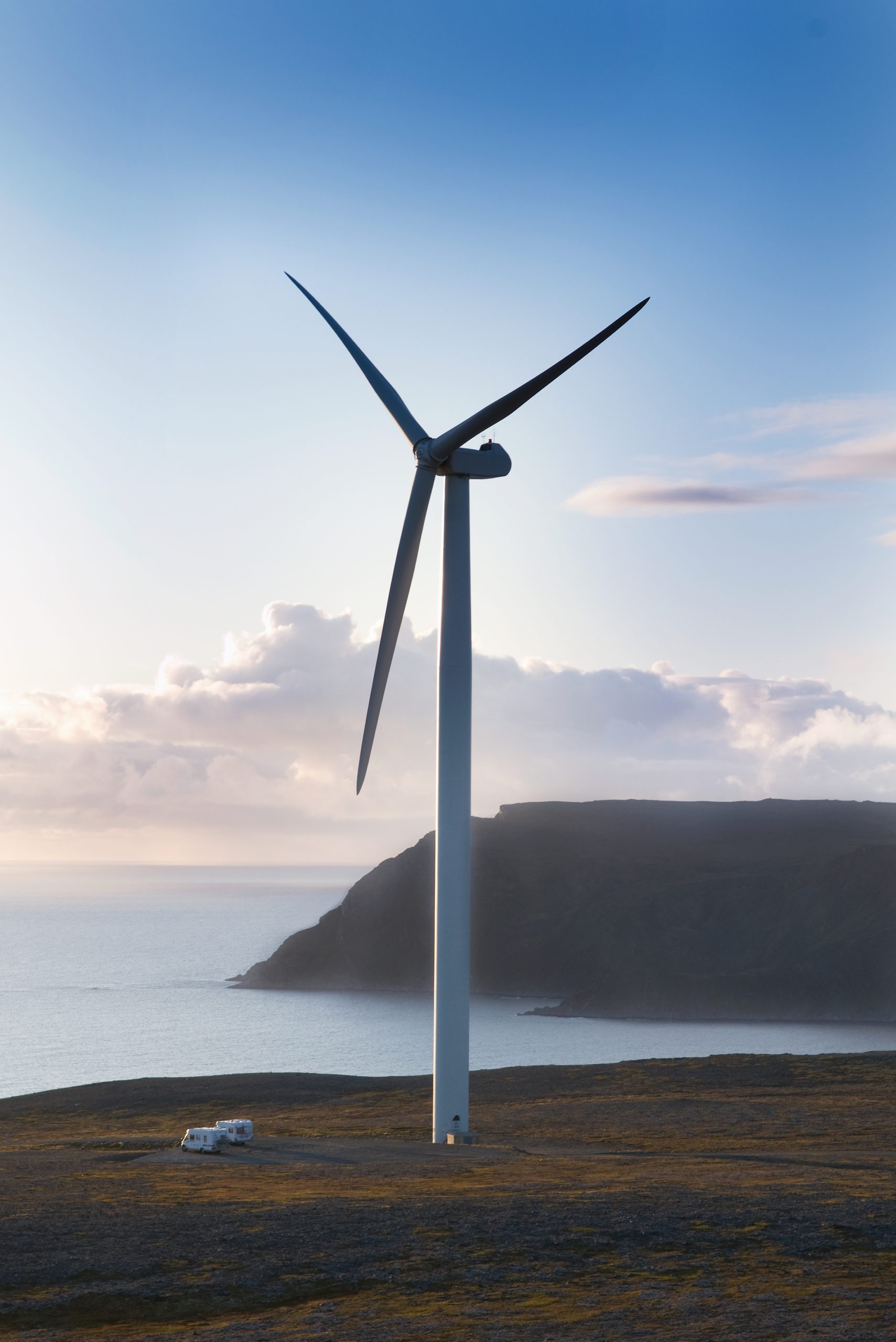 A wind turbine on a coastal hill