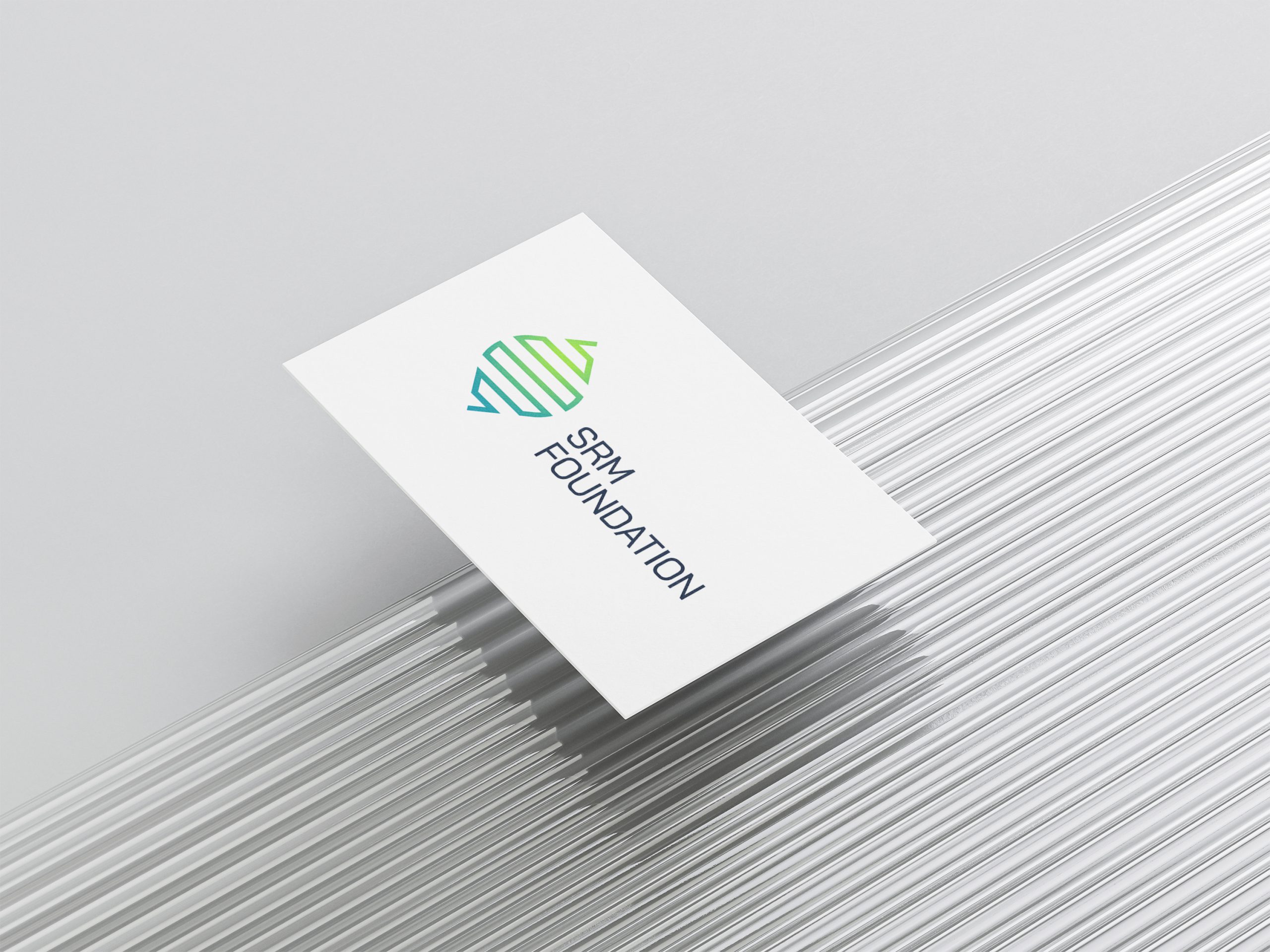 SRM Foundation business card on a stack of paper